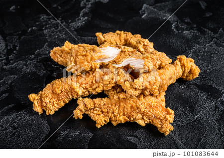 Breaded chicken strips Fingers, breaded breast meat. Black background. Top view 101083644