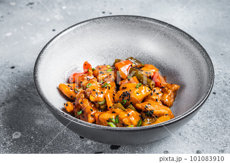 Chinese Sweet and Sour Pork guo bao rou in a bowl. Gray background. Top view Chinese Sweet and Sour Pork guo bao rou in a bowl. Gray background. Top view 101083910