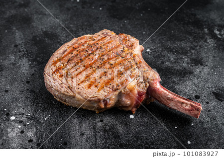 BBQ Grilled Tomahawk beef veal steak on butcher table. Black background. Top view 101083927