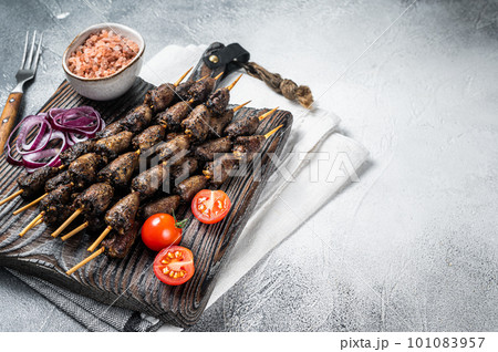Chicken hearts grilled on skewers with herbs and spices. White background. Top view. Copy space 101083957