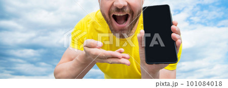 cropped view of man presenting smartphone screen with copy space 101084018