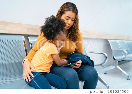family mom with daughter using phone together at room office 101084506