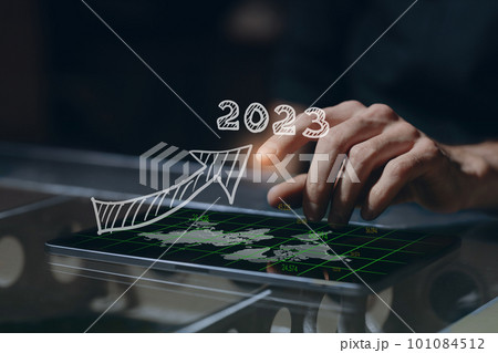 Business man hand on tablet PC screen with arrow growth chart graph businessman financial 2023 year strategy concept success growth template text 101084512