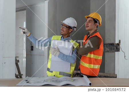 architect watching some details in blueprint a construction site architect watching some details in blueprint a construction site 101084572
