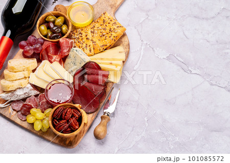 Antipasto board with prosciutto, salami, crackers, cheese Antipasto board with prosciutto, salami, crackers, cheese 101085572