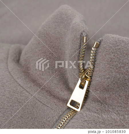Stand collar beige cashmere coat with golden zip. Close up 101085830