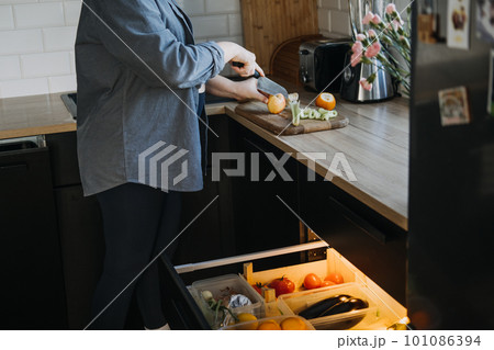 Food cravings during pregnancy. Why Pregnancy Can Make Have Weird Cravings. Craving fruits and vegetables during pregnancy. Pregnant woman cutting fruits in the kitchen 101086394