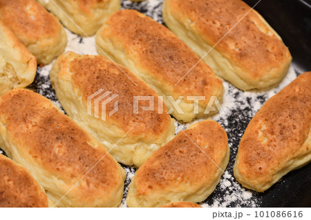Baked homemade pies on the baking sheet 101086616