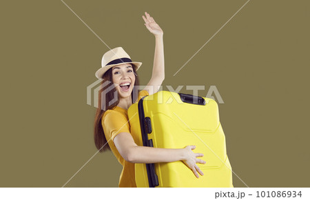 Smiling woman with suitcase excited about summer holidays 101086934