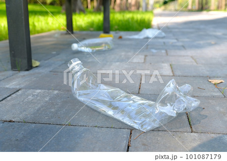 Garbage from plastic bottles, bags, paper, thrown away in a public park. Environmental problems. Garbage from plastic bottles, bags, paper, thrown away in a public park. Environmental problems. 101087179