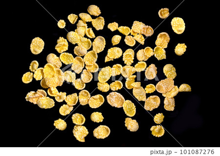 A pile of cornflakes isolated on a black background. View from above A pile of cornflakes isolated on a black background. View from above 101087276