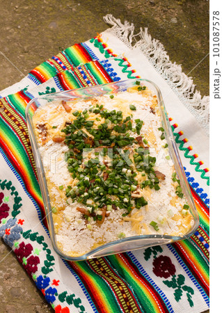 Banosh Hutsul cuisine. Corn porridge with cream, sheep cheese and green onions 101087578
