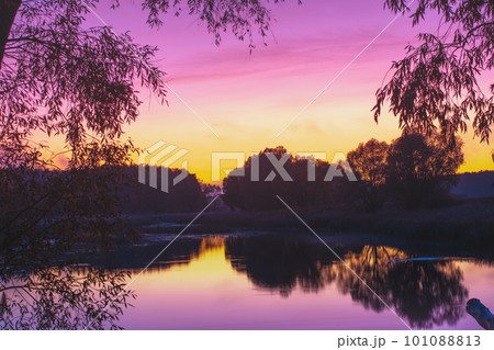 Magical sunset over the lake. Serene lake in the evening. Nature landscape. View from above Magical sunset over the lake. Serene lake in the evening. Nature landscape. View from above 101088813