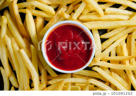 Tasty french fries and ketchup close-up. Background, top view Tasty french fries and ketchup close-up. Background, top view 101091202