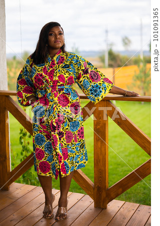 Beautiful african american woman enjoying evening on village and nature on terrace of country house. Diversity and inclusion and cottagecore concept 101091365
