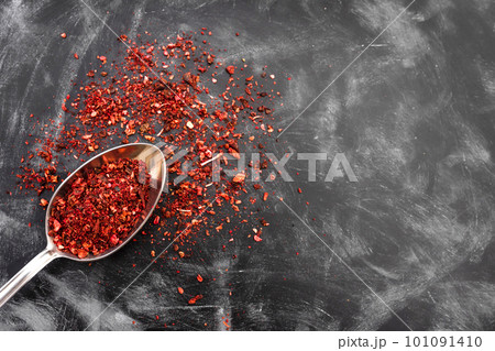 Spoon of spices on the working kitchen table. View from above Spoon of spices on the working kitchen table. View from above 101091410