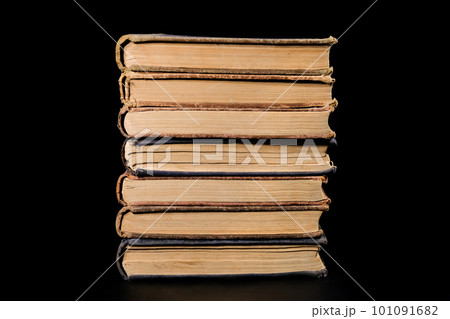 A stack of old books isolated on a black background, close-up. Education, training A stack of old books isolated on a black background, close-up. Education, training 101091682