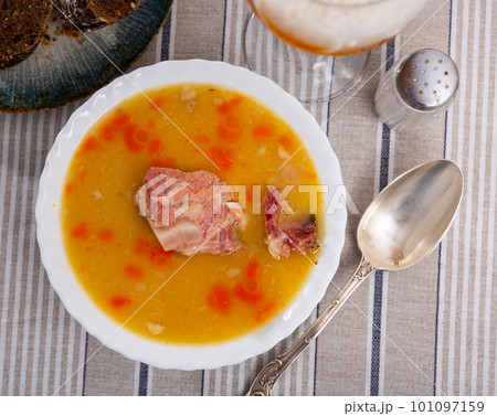 Hot pea soup with smoked meats and vegetables 101097159