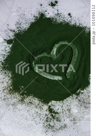 Heart on Blue-green algae Chlorella and spirulina powder. Super powder. Natural supplement of algae. Detox superfood drink cocktail. Food supplement source of protein and beta carotene Heart on Blue-green algae Chlorella and spirulina powder. Super powder. Natural supplement of algae. Detox superfood drink cocktail. Food supplement source of protein and beta carotene 101098112