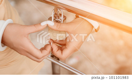 Hands, lock, heart, love, valentines day. Close-up of a woman's hands holding heart shaped padlock with a heart. The concept of Valentine's day, wedding, symbol of love and fidelity. 101101983