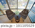 A chair made of rattan and a gypsophila on a table 101105029