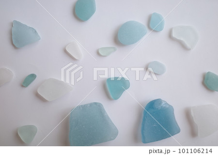 白背景の上に散りばめられた青と白のシーグラス 101106214