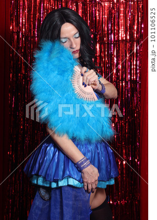 Woman Wearing Blue Corset Preforming Burlesque Dance With Feather Fan Woman Wearing Blue Corset Preforming Burlesque Dance With Feather Fan 101106525