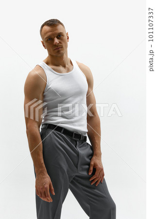 Sexy portrait of attractive muscular handsome male model posing at camera over white studio background Sexy portrait of attractive muscular handsome male model posing at camera over white studio background 101107337