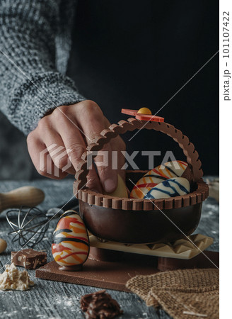 putting a chocolate egg in a spanish mona de pascua 101107422