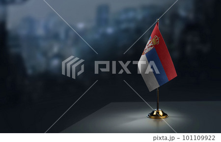 Small flags of the Serbia on an abstract blurry background 101109922