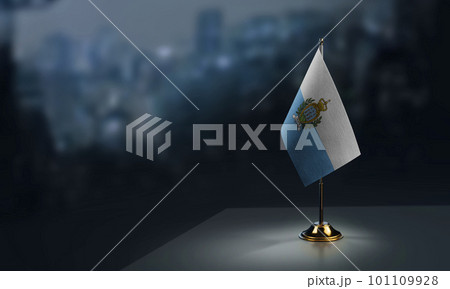 Small flags of the San Marino on an abstract blurry background 101109928