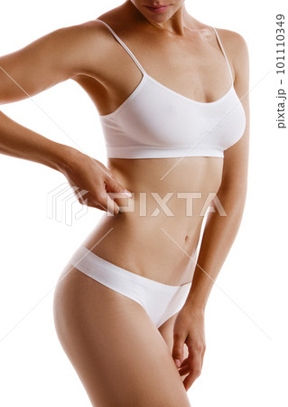 Young body of girl in white underwear, showing - Stock Photo [101110349]  - PIXTA