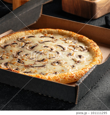 Take away backed mushroom pizza with cheese Take away backed mushroom pizza with cheese 101111295