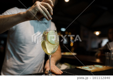 Bartender makes an alcoholic carbonated sweet cocktail at the bar. Alcoholic drinks at the bar or the nightclub. Night life 101112840