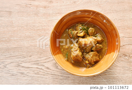 spicy fried pork bone with curry and basil leaf on bowl spicy fried pork bone with curry and basil leaf on bowl 101113672