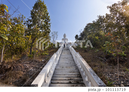 Tourists visiting Wat Phra That Mae Yen, or Big White Buddha is huge white Buddha stands on a hill with 353 steps, in Pai, popular tourist destination in Thailand. 101113719