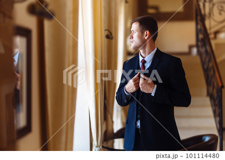 Luxury groom in suit. Businessman. The morning of the groom, bridegroom's fees. Sexy man in suit posing. Luxury groom in suit. Businessman. The morning of the groom, bridegroom's fees. Sexy man in suit posing. 101114480