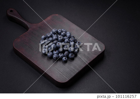 Delicious fresh blueberries on a textural black concrete background 101116257