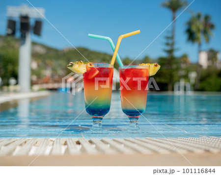 Relax by the pool. Summer vibrant cocktails with a straw sit by the pool. Relax by the pool. Summer vibrant cocktails with a straw sit by the pool. 101116844