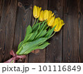Yellow tulips lie on a wooden rustic table. Spring holidays concept background and mother day. 101116849