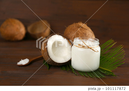 Composition with organic coconut oil on wooden table. Healthy cooking 101117872
