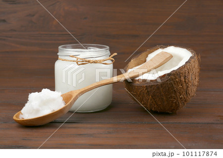 Composition with organic coconut oil on wooden table. Healthy cooking Composition with organic coconut oil on wooden table. Healthy cooking 101117874