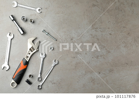 Auto mechanic's tools on grey background, flat lay. Space for text Auto mechanic's tools on grey background, flat lay. Space for text 101117876