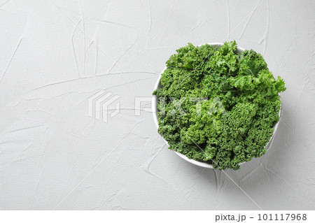 Fresh kale leaves on white table, top view. Space for text Fresh kale leaves on white table, top view. Space for text 101117968