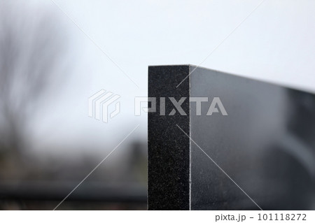 Black granite tombstone outdoors, closeup with space for text. Funeral ceremony 101118272