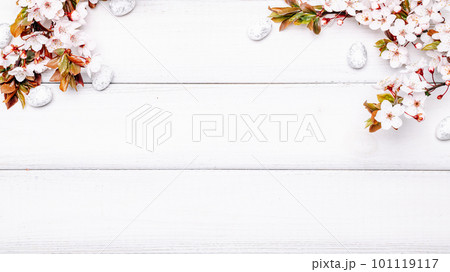 Easter white background. Spring flower border, white happy easter egg on wooden spring background. Easter card. Flat lay. Easter white background. Spring flower border, white happy easter egg on wooden spring background. Easter card. Flat lay. 101119117