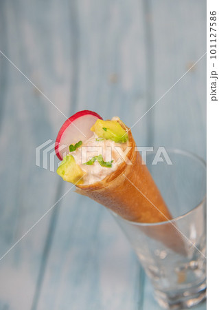 Brick cone with tuna sauce, mayonnaise, avocado and radish slice 101127586