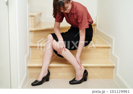 Asian business woman pain ankle, foot with leg cramp and fall down the stairs because slippery surfaces in office. Asian business woman pain ankle, foot with leg cramp and fall down the stairs because slippery surfaces in office. 101129961