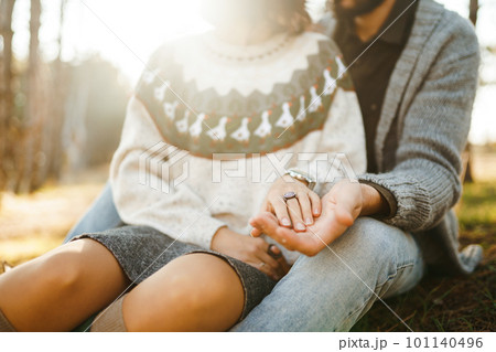 Lovers hold hand. Lovely hipster couple enjoying each other. Couple wearing beautiful hats, sweaters 101140496