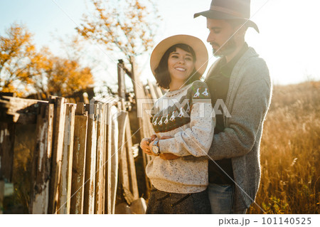 Lovely hipster couple looking at each other. Couple wearing beautiful hats and sweaters. 101140525